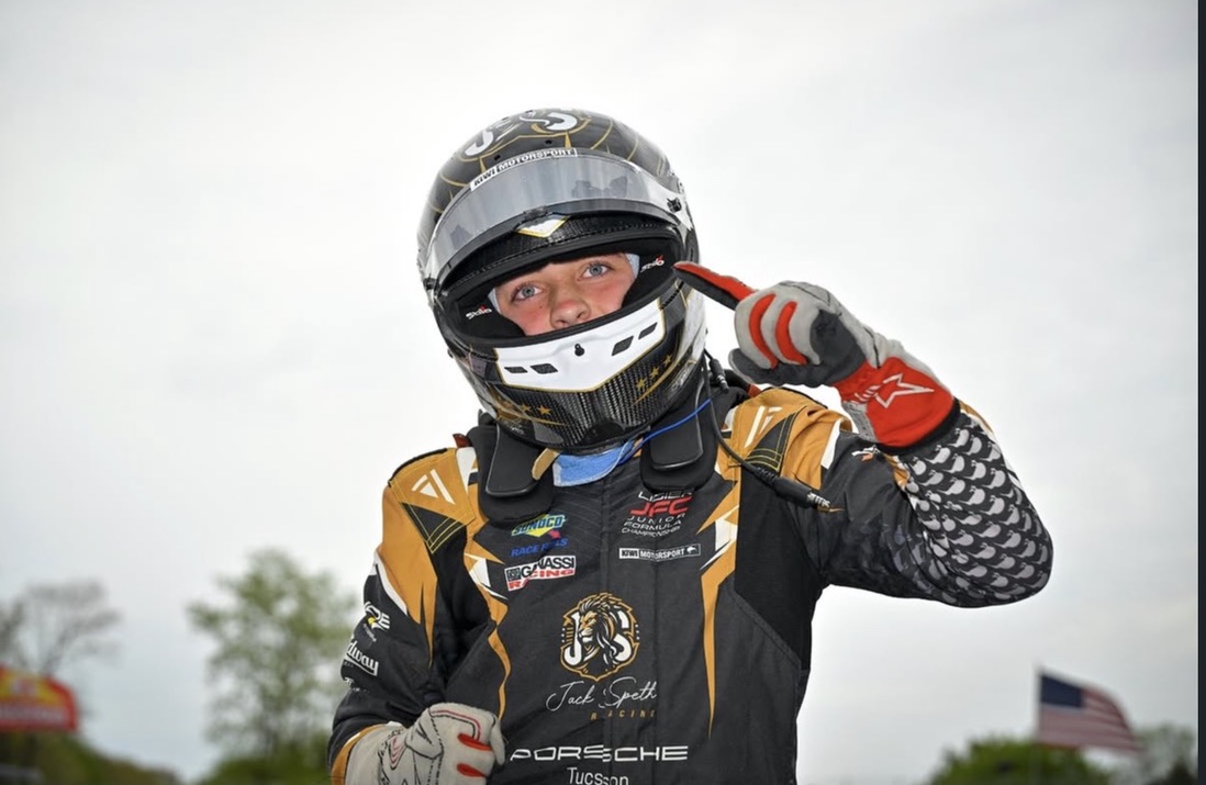 Jack Speth pointing skyward in his helmet