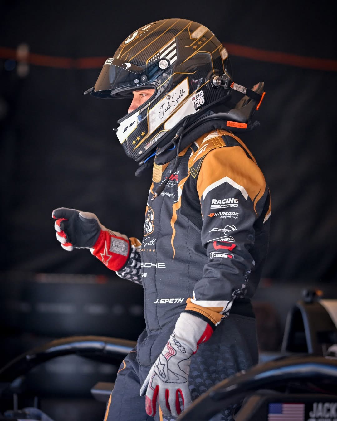 Jack Speth walking through the paddock in his race suit